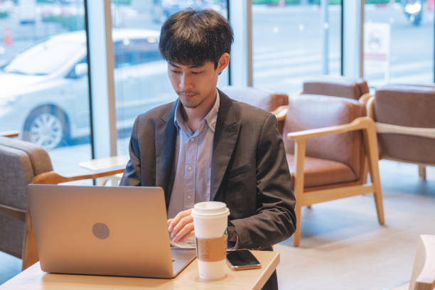 istock Young man sitting in office and working on laptop. 1265266578