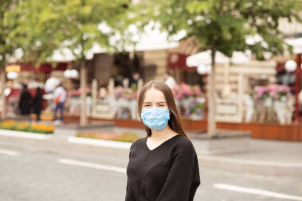 istock student girl in a protective mask walks around the city 1265266875
