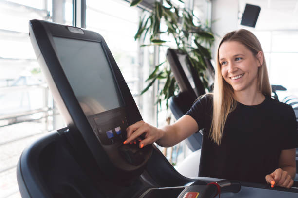 istock Beautiful young woman in a gym preparing for workout 1265268524
