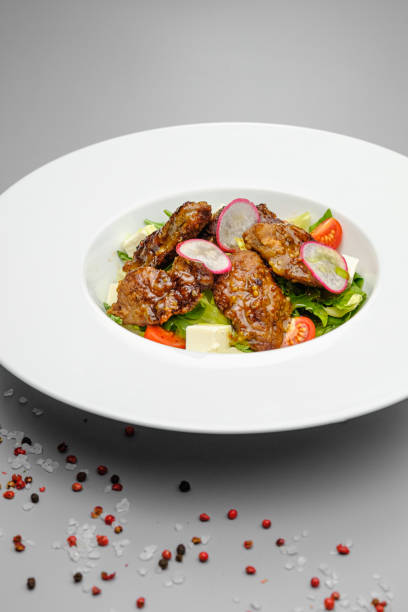 istock Grilled beef in a sauce with Dejon mustard and soft cheese in a case plate on a gray background. 1265276324