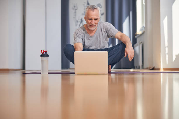 istock Sporty man looking at the laptop screen 1265278720