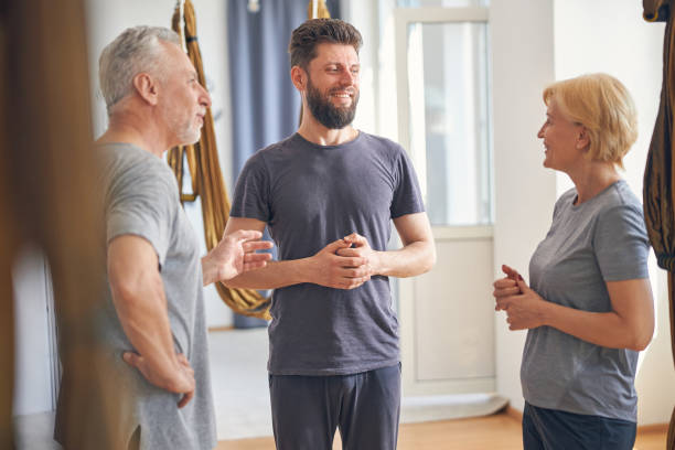 istock Young instructor looking at a mature lady 1265278963