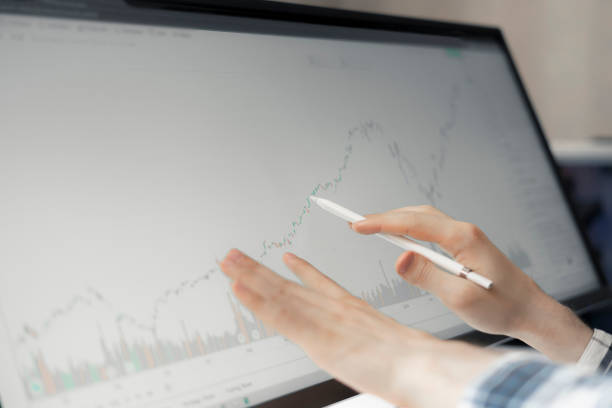 istock male trader watching the stock graph on big computer screen at home, chart analysis 1265279661