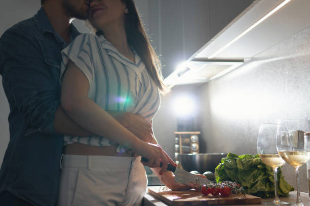 istock Young couple cooking tasty dinner together in a kitchen 1265279989