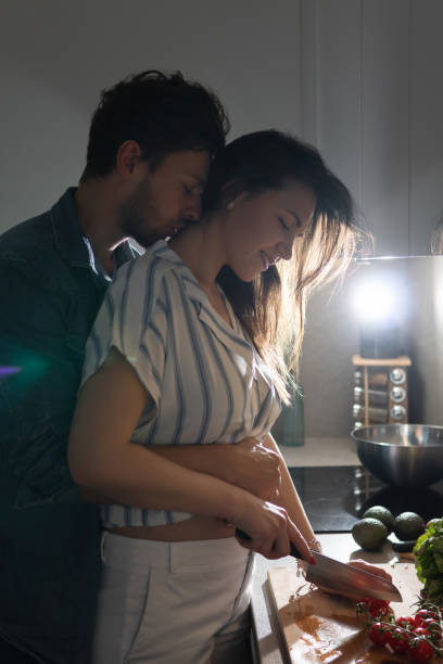 istock Young couple cooking tasty dinner together in a kitchen 1265280153