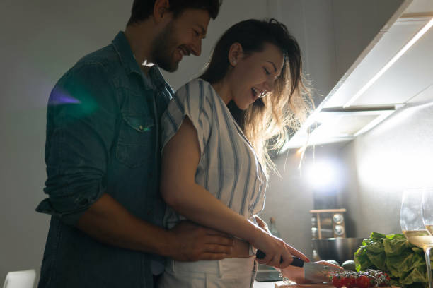 istock Young couple cooking tasty dinner together in a kitchen 1265280227