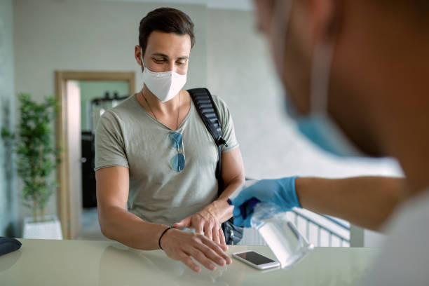 istock Athletic man getting his hands disinfected while checking in a gym during coronavirus epidemic. 1265280288