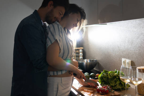 istock Young couple cooking tasty dinner together in a kitchen 1265280293