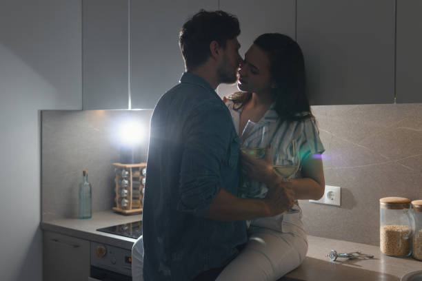 istock Sensual couple drinking wine and relaxing at home 1265281912