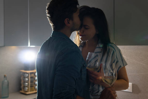 istock Sensual couple drinking wine and relaxing at home 1265282117