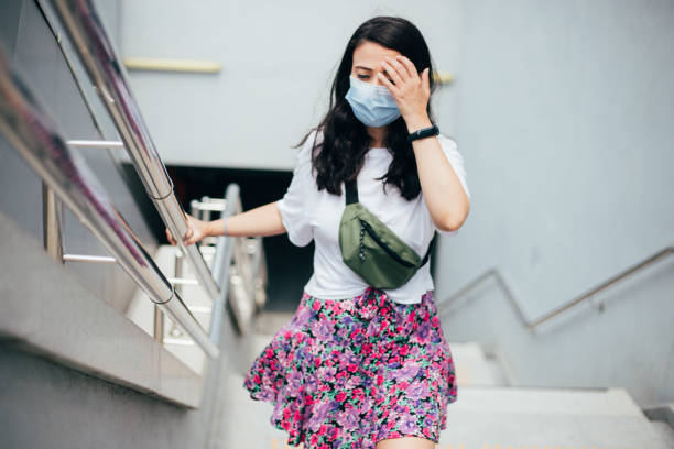 istock Woman suffering from dizziness holding hand rai 1265282428