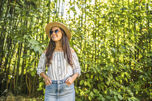 Portrait of happy fashion woman in rainforest