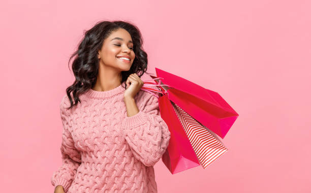 istock Friendly ethnic shopper with paper bags 1265284676
