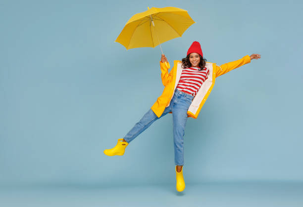 istock Excited ethnic female leaping with umbrella 1265284684
