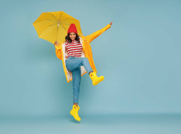 istock Excited ethnic female leaping with umbrella 1265284740
