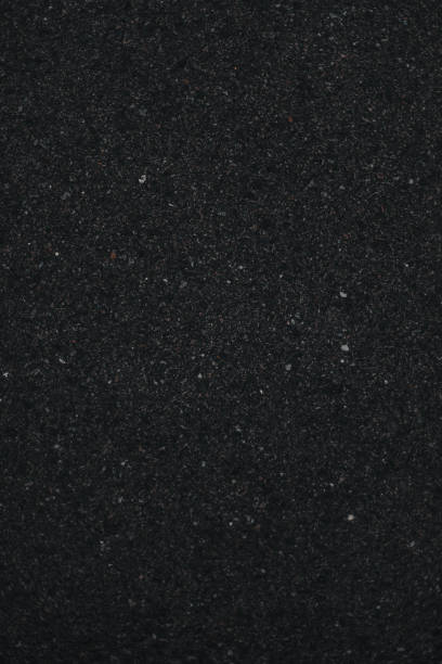 istock Dark asphalt concrete texture, dark stone material background 1265288054