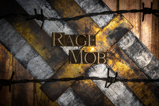 Photo of real authentic typeset letters forming Rage Mob text on vintage textured silver grunge copper and gold background Letters on silver and gold background with rusty barbed wire tear gas photos stock pictures, royalty-free photos & images