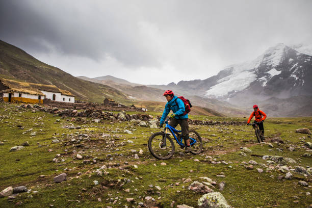 Two mountain bikers on adventure. Mountain bikers riding through Peruvian Andes.  Ausangate bike packing trip, Peru. andes photos stock pictures, royalty-free photos & images
