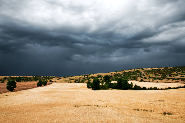 Dramatic stormy dark cloudy sky over field. Natural photography in France