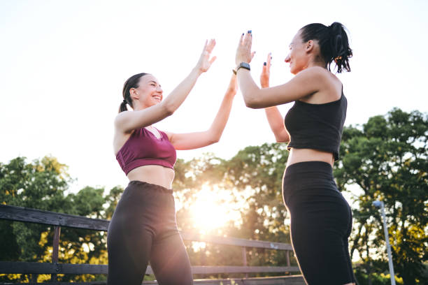 istock Cheerful female athletes doing a high-five outdoors during a training 1265293455