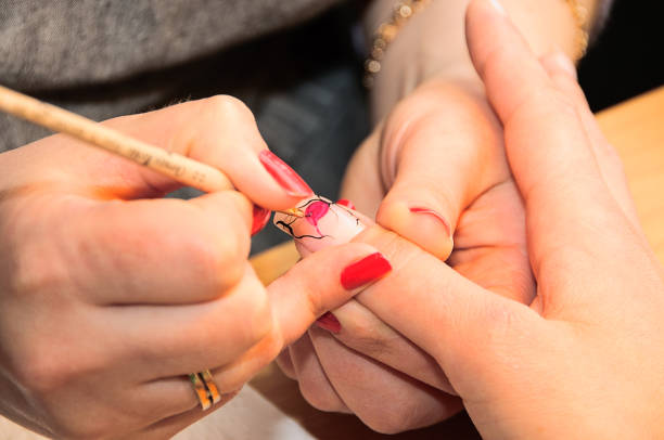 istock Manicure. Drawing a picture on a nail 1265297260