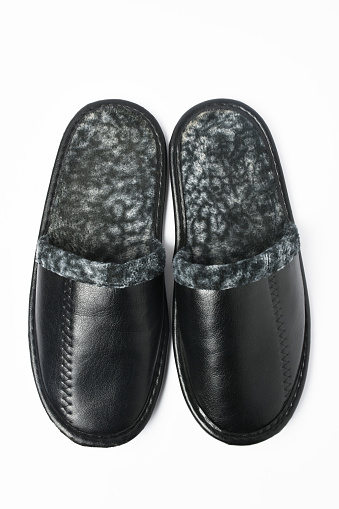 A pair of leather slippers on the white background