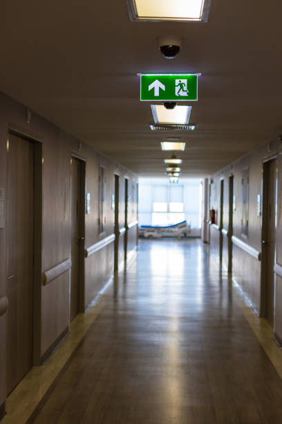 istock Green emergency exit sign showing the way to escape.Fire exit in the building. 1265299957