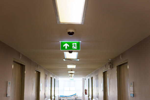 istock Green emergency exit sign showing the way to escape.Fire exit in the building. 1265299960