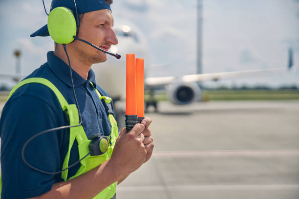 istock Signalman holding wands in front of him 1265300131