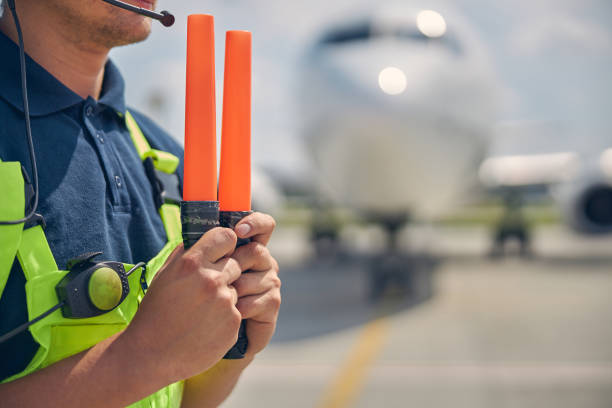 istock Ground marshaller standing on the landing field 1265300132