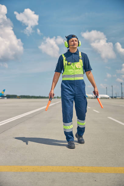 istock Young Caucasian signalman in headset walking forward 1265300142