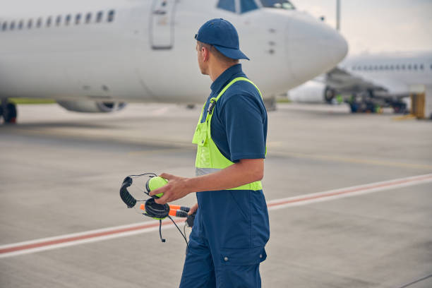 istock Signalman in uniform standing at the airdrome 1265300144