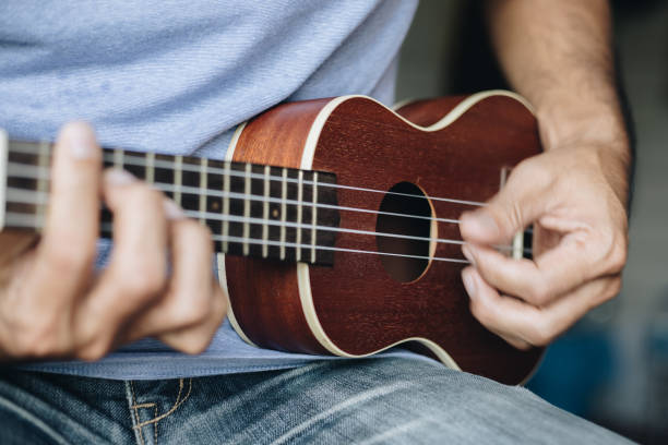 istock A young man playing the ukulele, Concept music player 1265301540