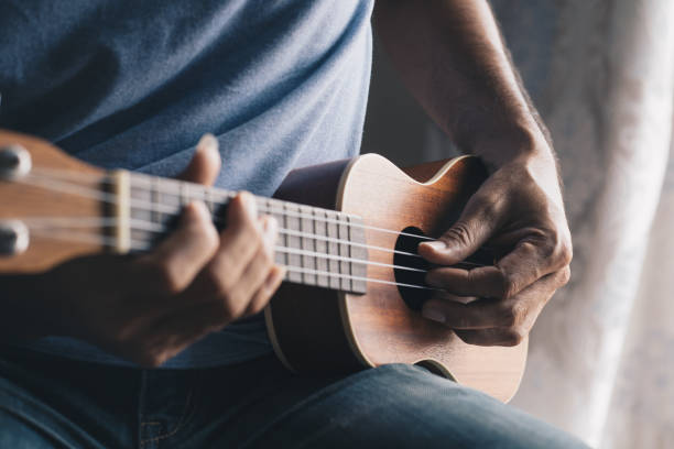 istock A young man playing the ukulele, Concept music player 1265301541