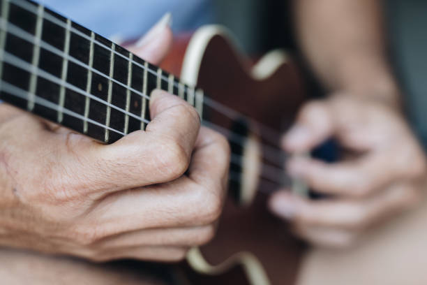istock A young man playing the ukulele, Concept music player 1265301556