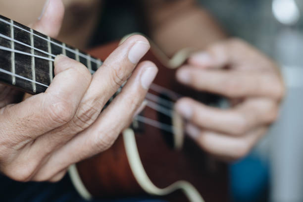 istock A young man playing the ukulele, Concept music player 1265301561