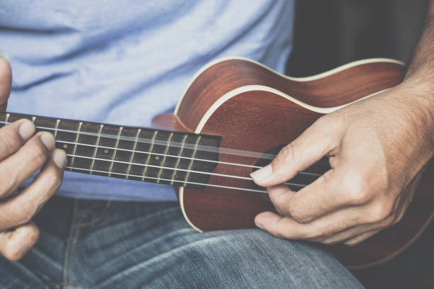 istock A young man playing the ukulele, Concept music player 1265301567