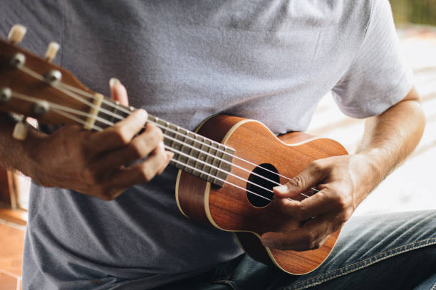 istock A young man playing the ukulele, Concept music player 1265301570