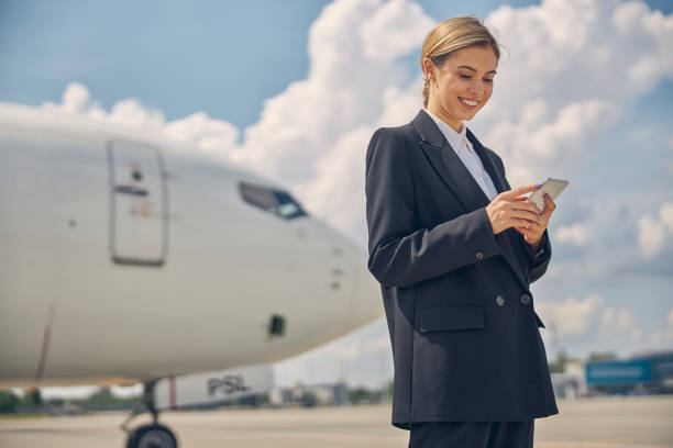 istock Smiling woman reading a text message on her cellphone 1265304546
