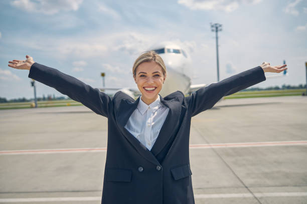 istock Pleased airport worker looking in front of her 1265304584