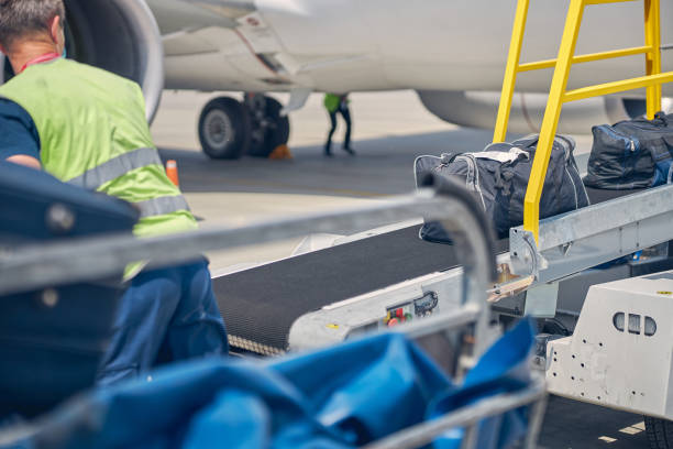 istock Airport male worker looking at the baggage 1265305346