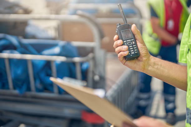istock Man holding a walkie-talkie and a clipboard 1265305354