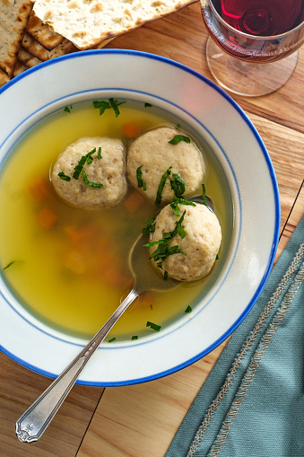 Delicious Matzoh ball soup with crackers and wine