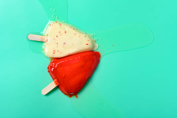 istock top view two different colors chocolate outer popsicles melting on light green color 1265313635
