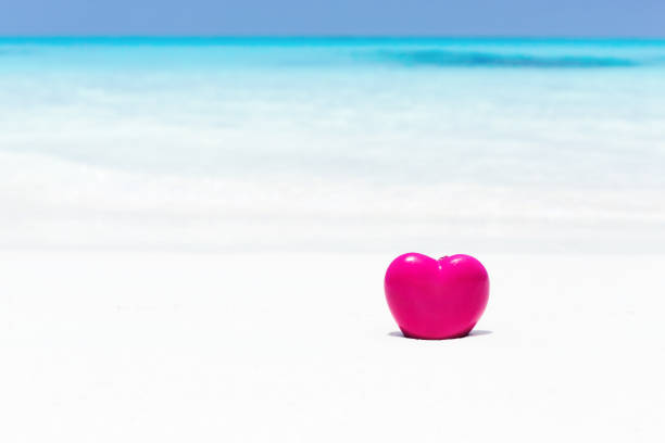 istock Valentines day concept greeting card, red heart on pristine sandy beach 1265315570