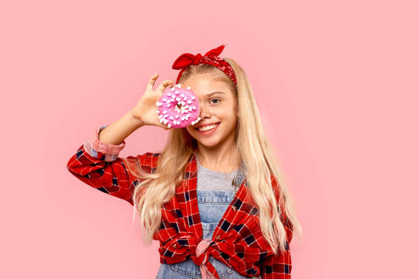 Little girl cover eye with sweet donut