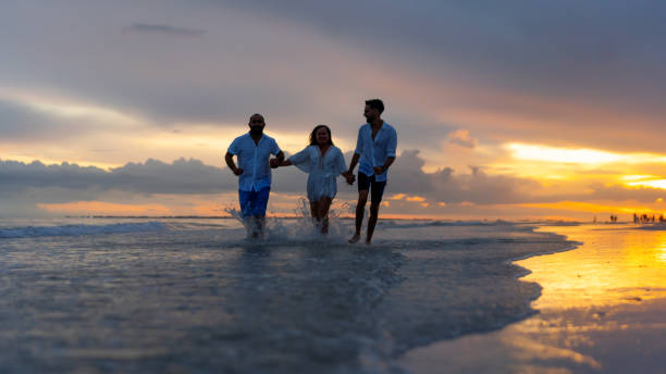 istock Family of three on the beach 1265330035