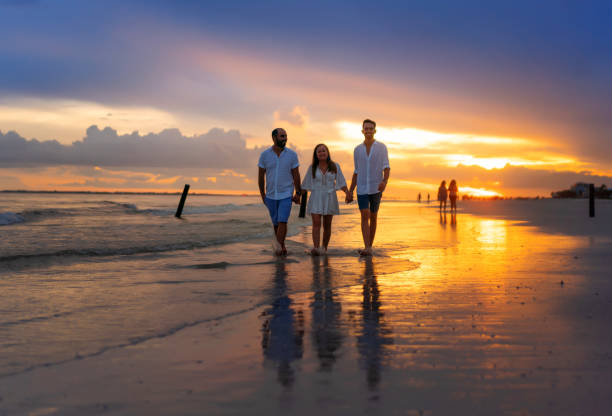 istock Walking on the beach at sunset Florida 1265330581