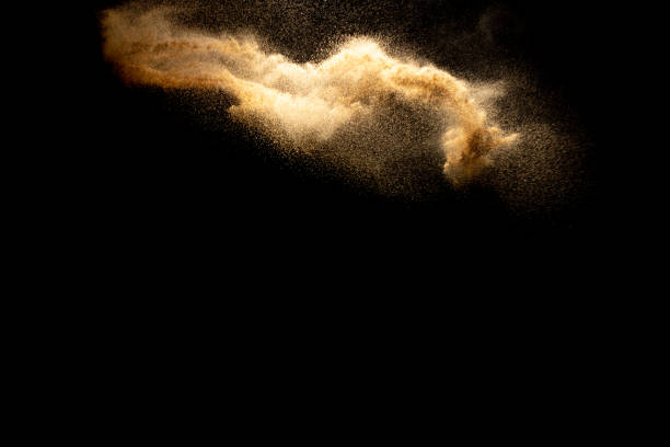 istock Abstract motion blurred brown color sand splash against black background. 1265357800