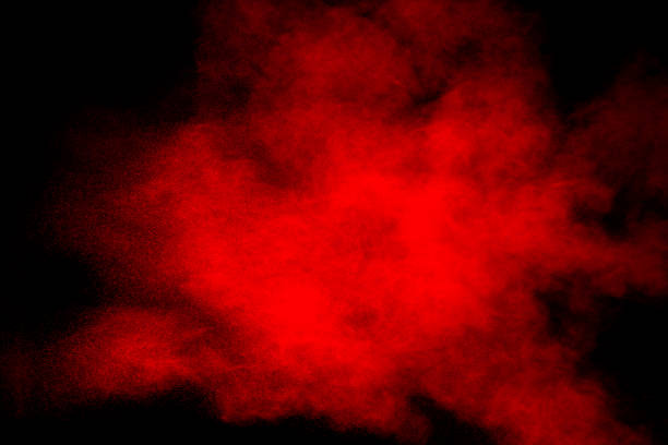 istock Red powder explosion on black background. Freeze motion of red dust particles splash. 1265363700